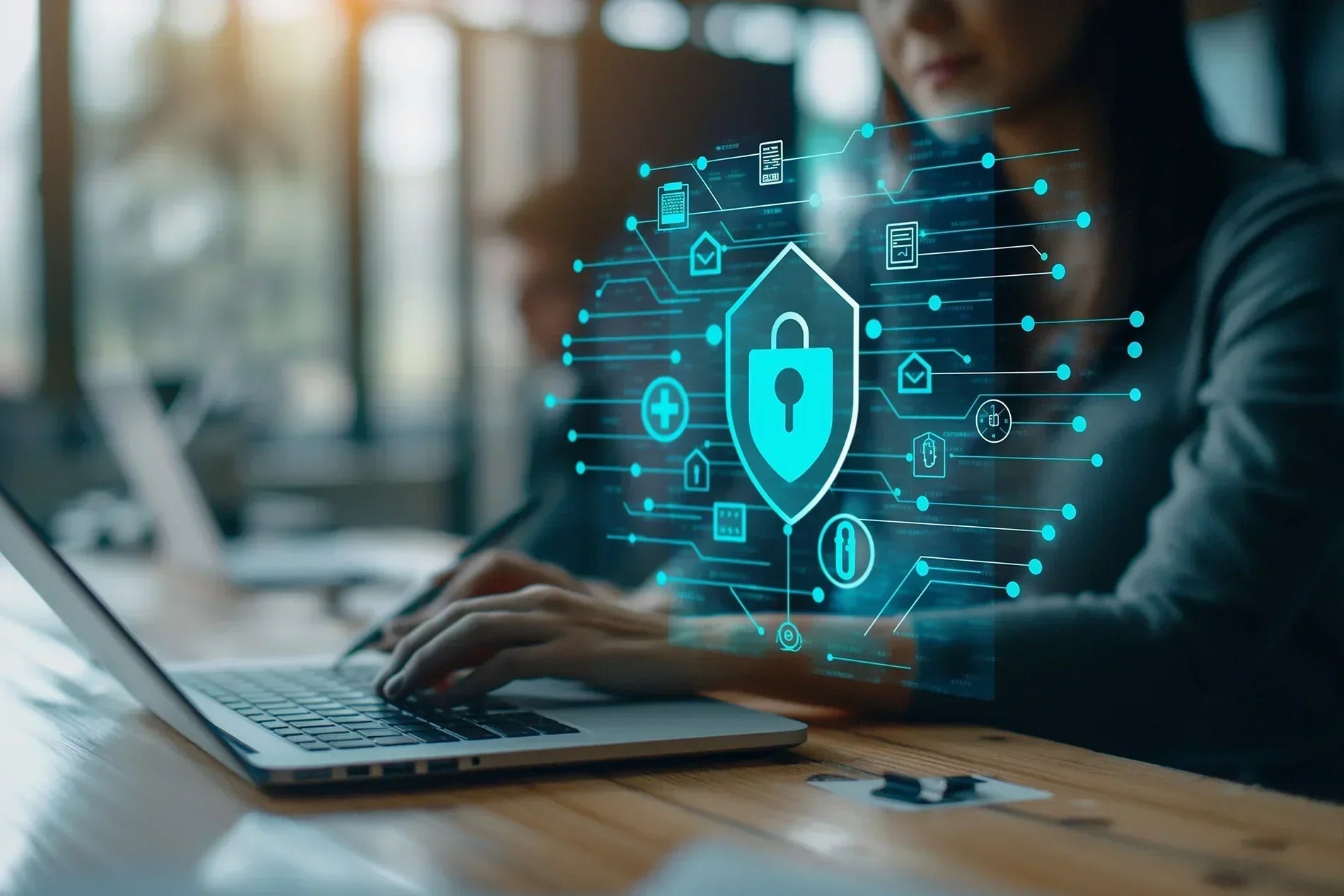 Woman working on laptop with holographic security lock floating next to the laptop. 