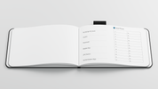 Open The IndeX notebook with designated sections for exchange account details, user IDs, passwords, master keys, 2FA devices, and a 24-word seed phrase table, designed for secure crypto storage.
